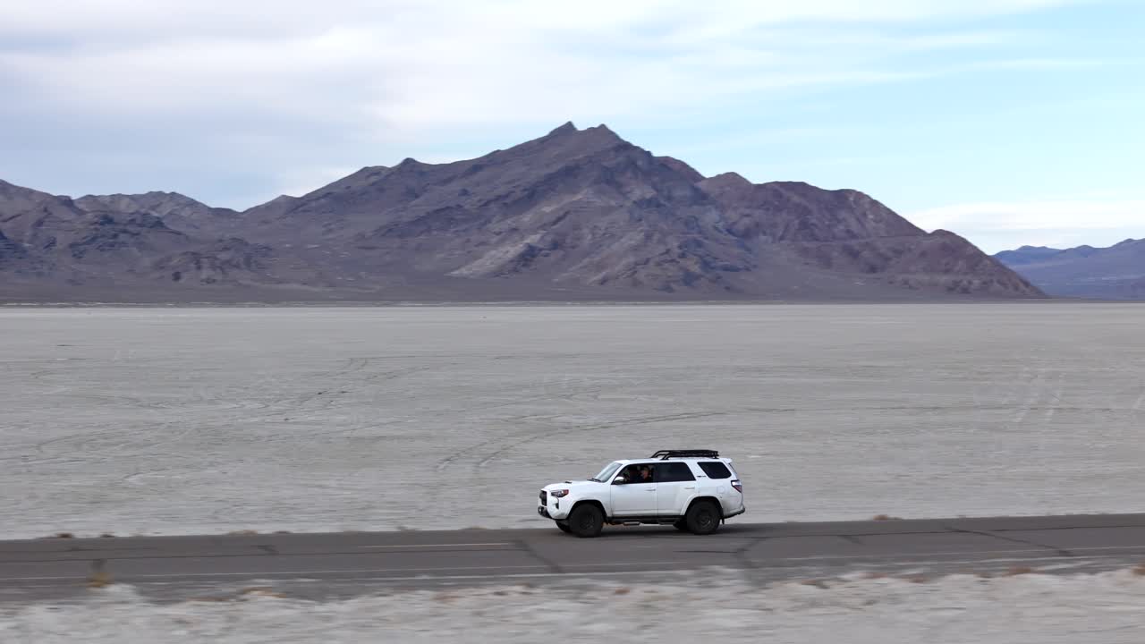 Drone Shot of White SUV Vehicle on Road in Bonneville Salt Flats, Utah USA