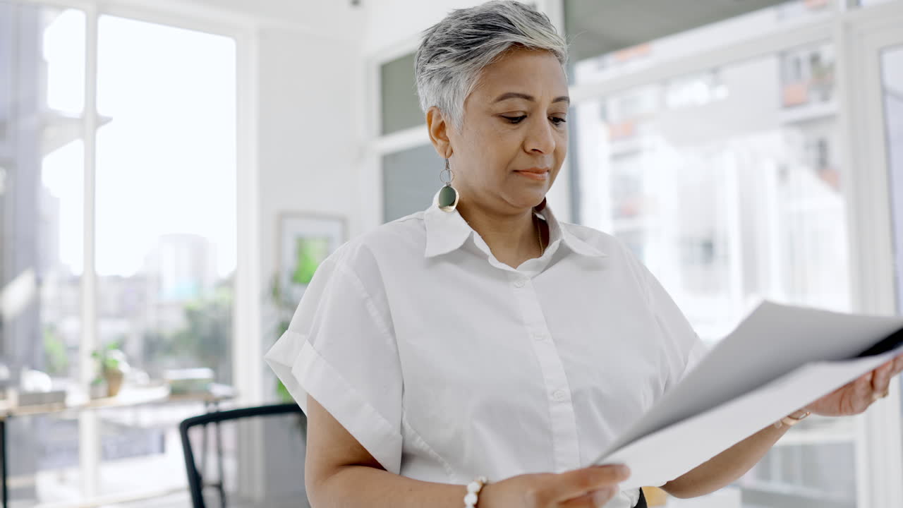 Business woman reading paperwork documents