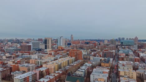 Wide-shot-flying-over-New-York-City-in-Harlem,-day,-4K-drone