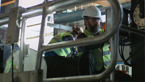 industrial workers repairing machinery