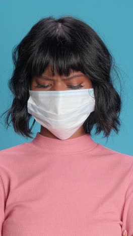 emotional expression of a young woman in a mask against a vibrant backdrop