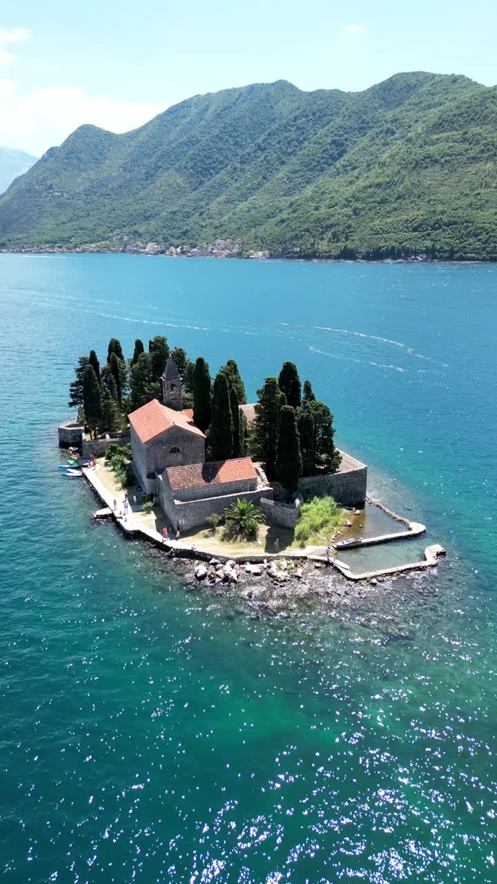 Drone view of Sveti Dorde Island - Saint George Monastry in the middle of the island. Vertical aerial perspective. Drone circling arround the island. Travel destination