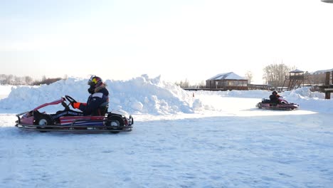 children enjoying snow karting on a winter day