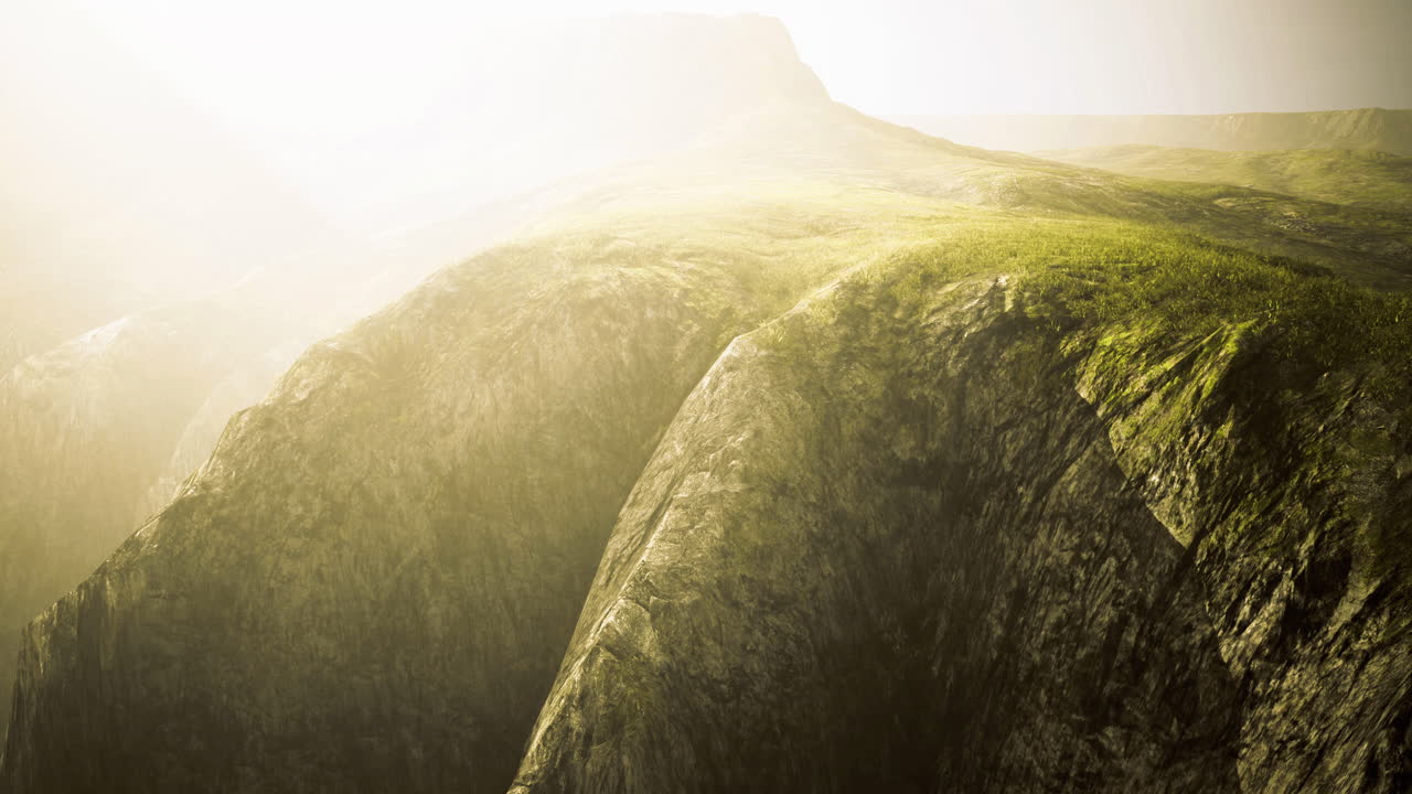 Majestic cliffs bask in soft morning light near rugged landscape