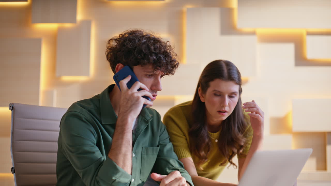 Colleagues working together on a laptop in the office