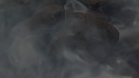 charcoal-close-up-with-a-lot-of-smoke-going-in-different-directions,-SLOW-MOTION