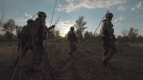 soldiers on patrol at sunset