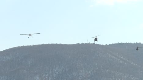 military aircraft flies over war zone