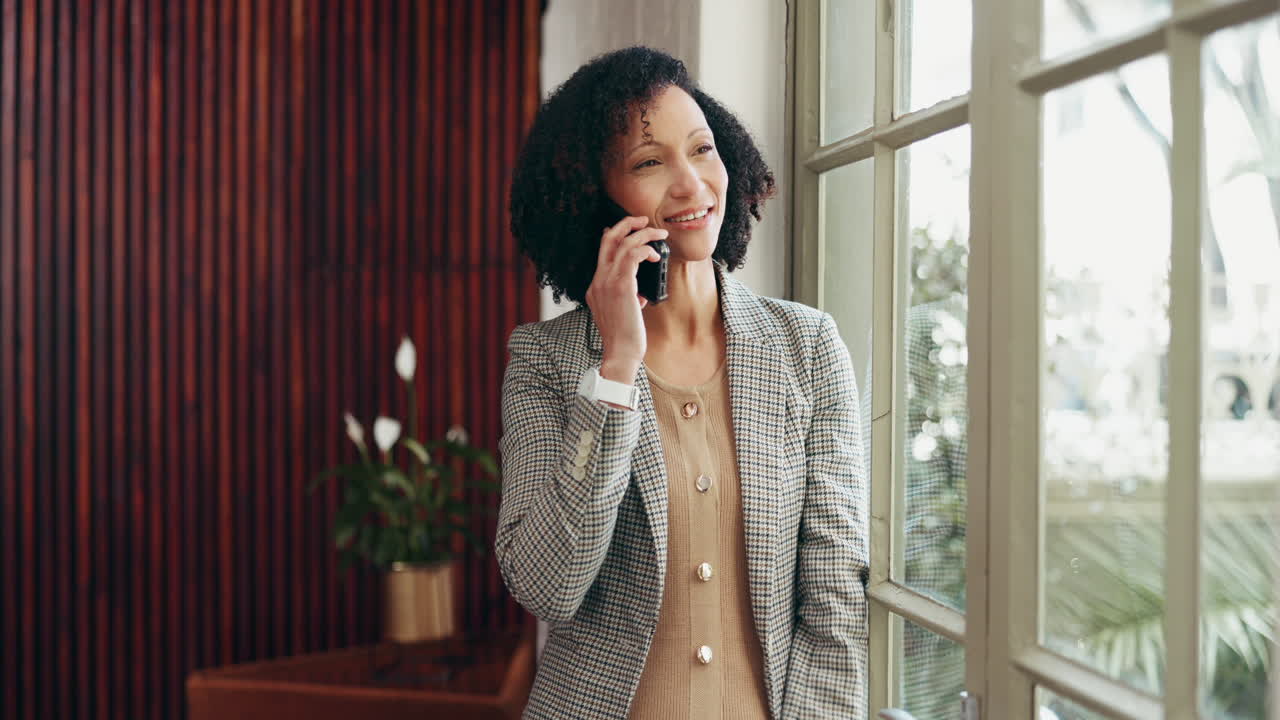 Businesswoman on a Phone Call by the Window