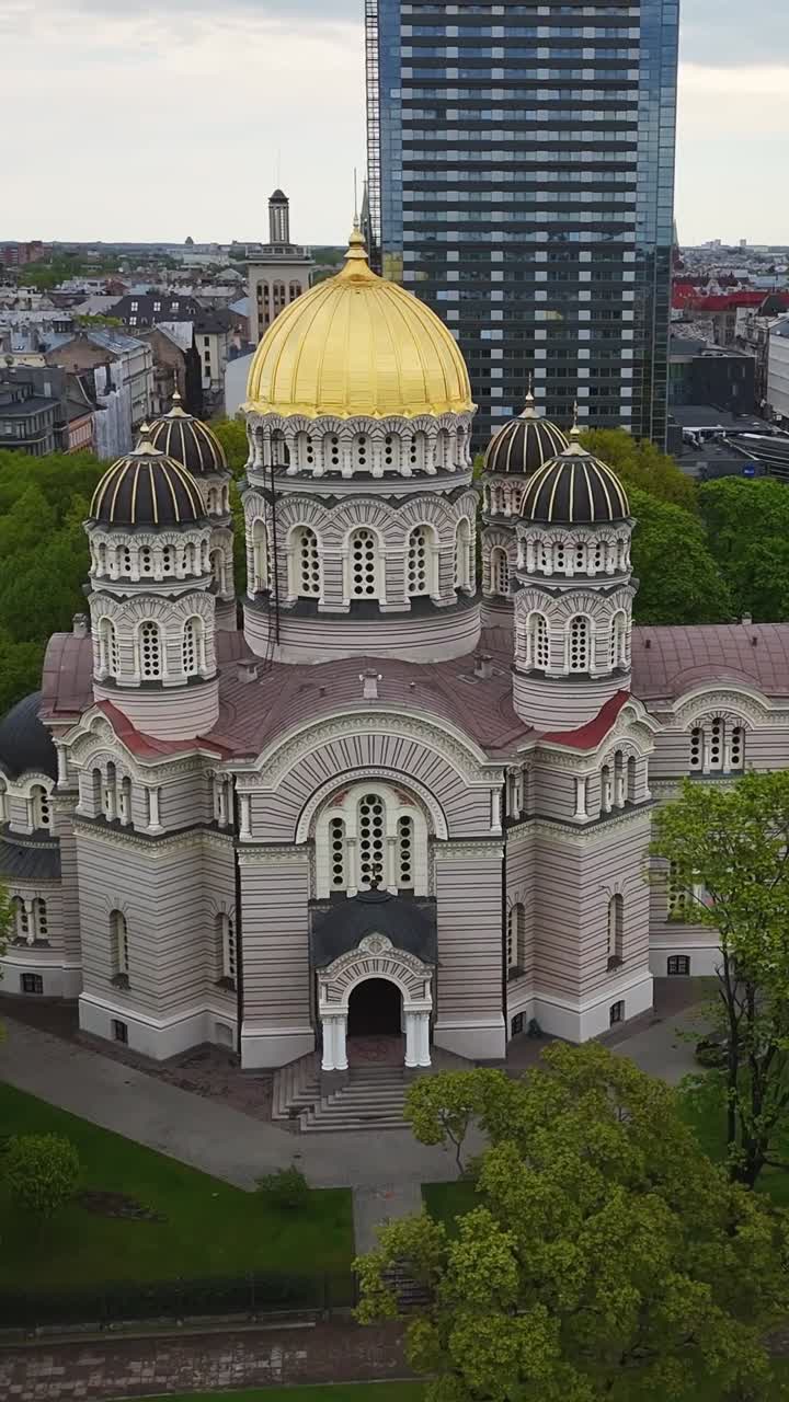 Vertical shot showcases the gold-domed Orthodox cathedral in Riga’s historic city center.