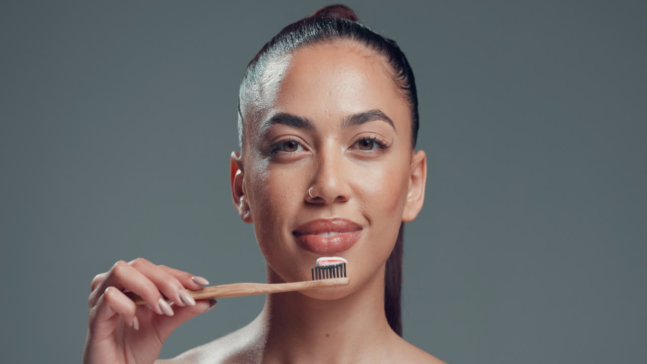 Woman brushing teeth with a toothbrush