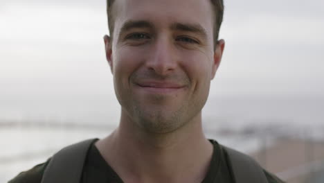 close-up-portrait-of-charming-young-man-smiling-laughing-feeling-positive