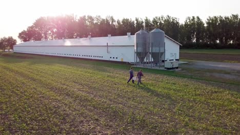 Aerial-view-of-farmers-walking-across-the-field