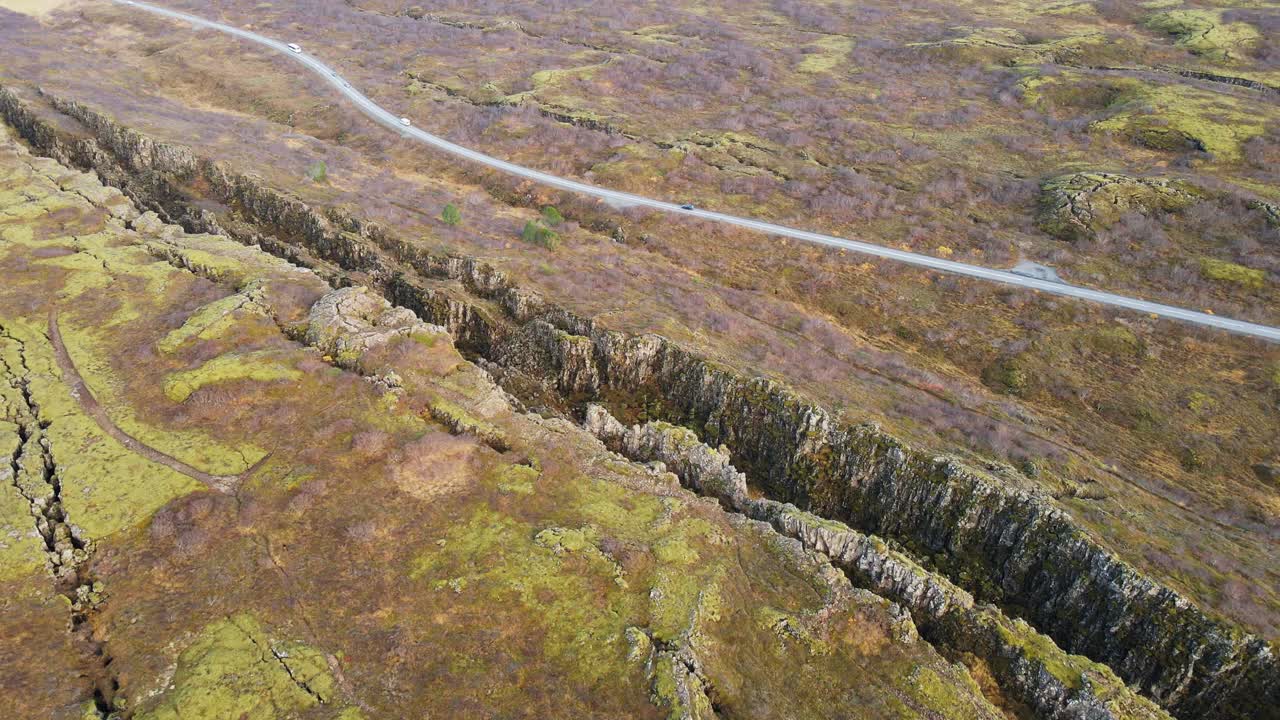 Drone flying towards beautiful Langist&iacute;gur canyon in Thingvellir national park in Iceland