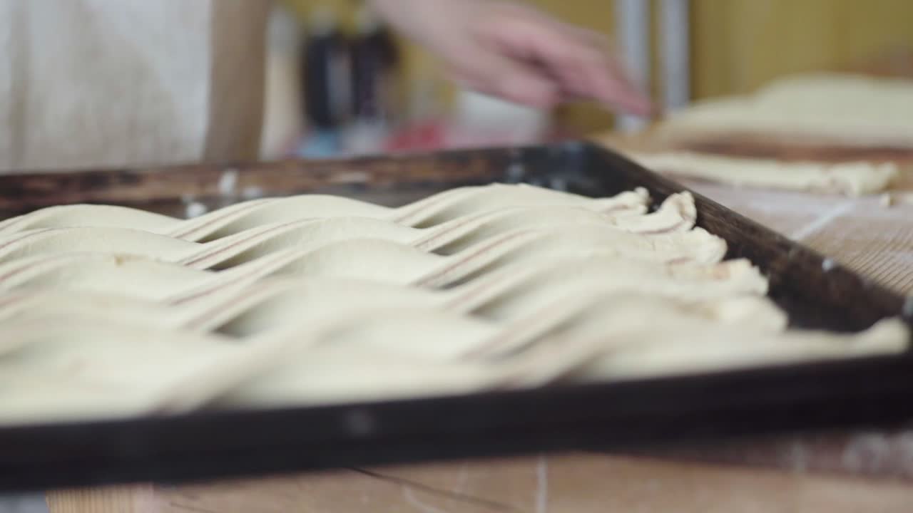 Bakery chef making cinnamon twist, Closeup, handheld shot