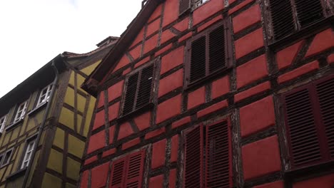 colorful red and green alsace wood framed homes in strasbourg, france