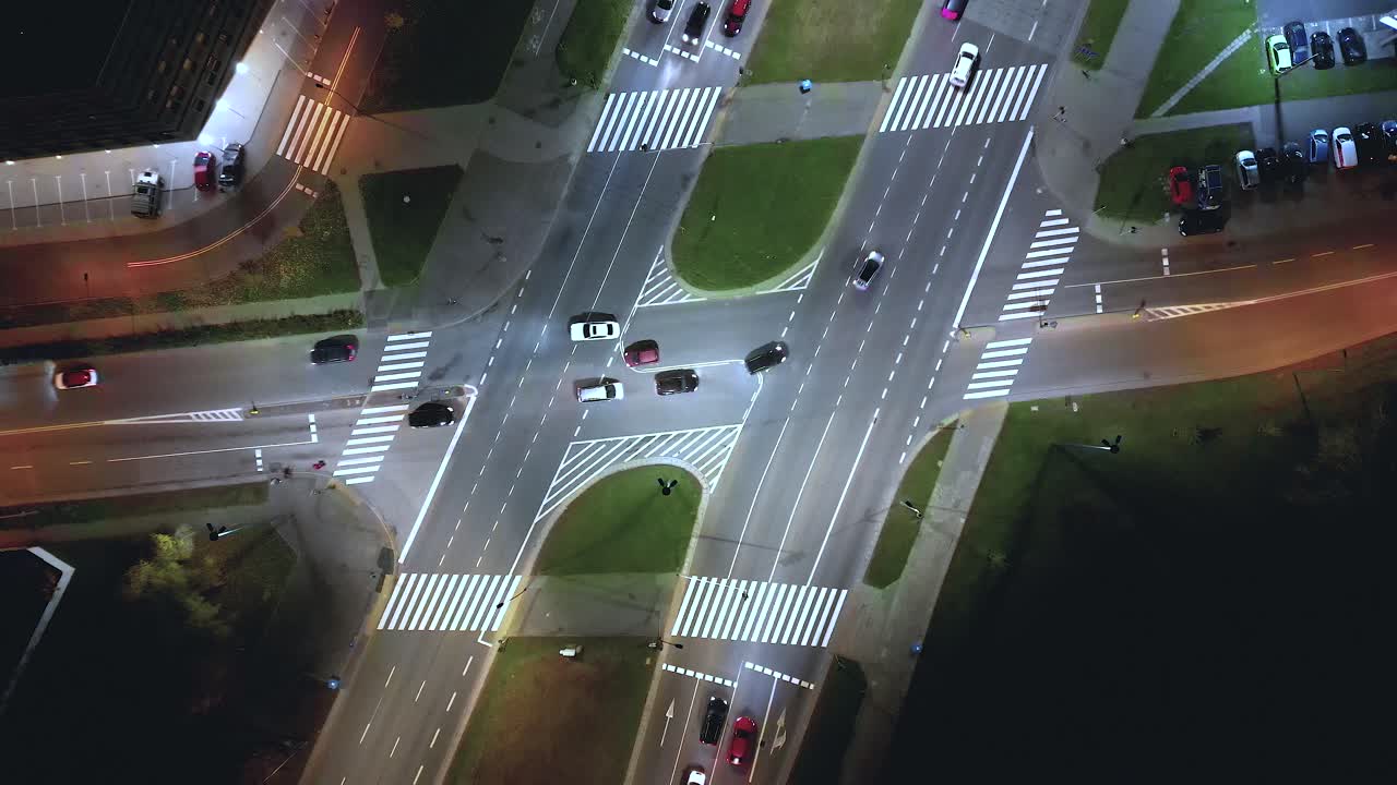 Rising drone shot reveals spectacular elevated highway and convergence of roads, bridges, viaducts at night, transportation and infrastructure development