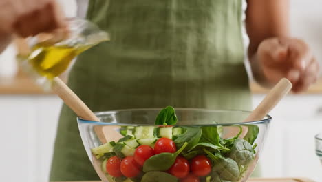 preparing a fresh healthy salad with olive oil