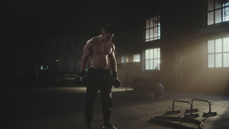 man working out with dumbbells in a gym