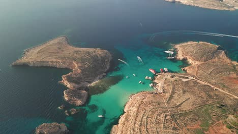 aerial drone footage of malta's iconic blue lagoon, renowned for its mesmerizing turquoise waters