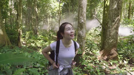 woman hiking in a lush tropical forest