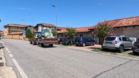 tractor towing machinery through a residential street