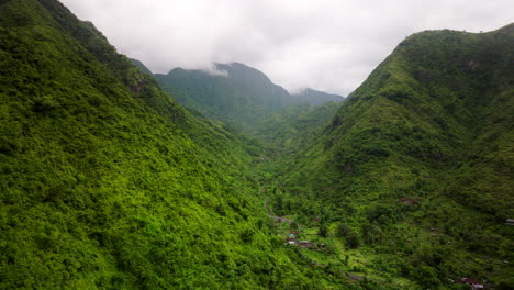 Desolate-houses-between-lush-and-tropical-mountains-of-Amed-village,-Bali-in-Indonesia