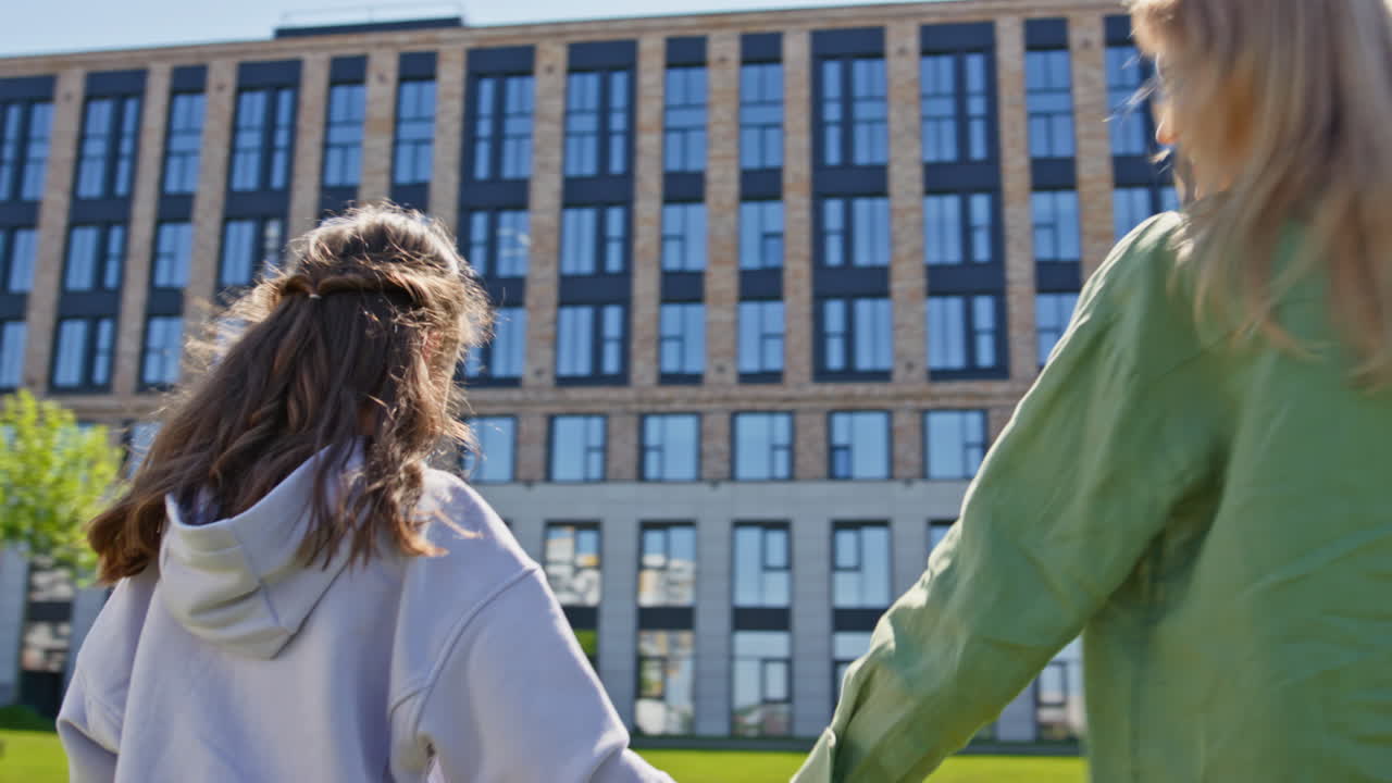 Cheerful blondie rejoicing summer at meadow closeup. Mother daughter strolling