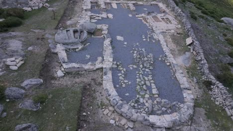 flight with a drone over the archaeological remains of a visigoth church 6th-7th centuries ad where there are tombs inside the structure, outside we see areas excavated by archaeologists in avila