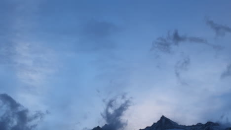 Swiss-alps-autumn-first-snow-dusting-mountain-peaks-Saas-Fee-Zermatt-Saastal-alpine-valley-chalet-ski-resort-town-sunset-orange-pink-high-clouds-fog-Switzerland-Europe-Lark-tree-wind-pan-down