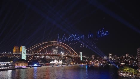 written in the stars - drone light display in front of sydney harbour bridge during vivid light festival 2023