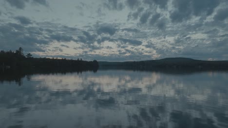 Low-angle-aerial-showing-scenic-symmetry-Lake-Hebron-reflecting-the-morning-sky