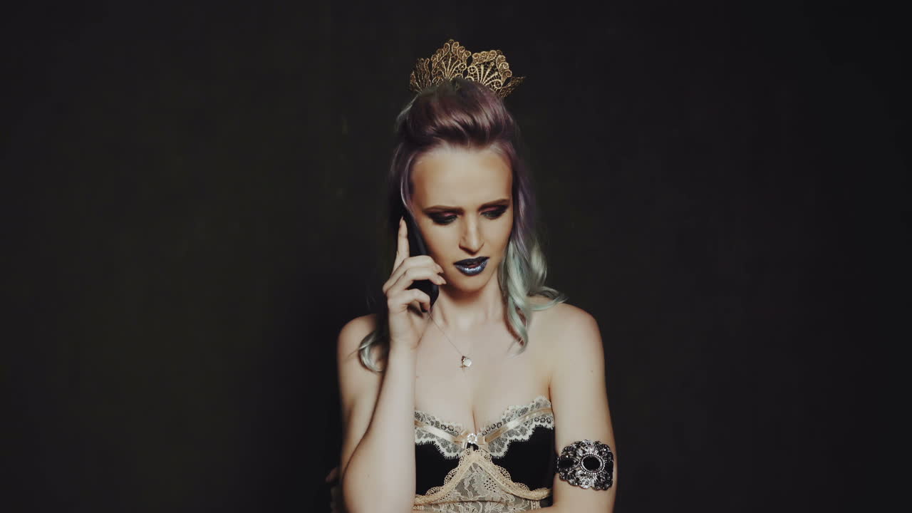 Woman using phone in studio. Young fashion woman talking on smartphone in studio