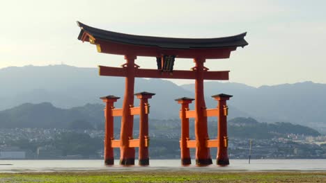 The-great-giang-red-Tori-of-Itsukushima-temple-at-Miyajima-Hiroshima-Japan-Timelapse-no-tourist-tide-begin-to-cover-at-sunset