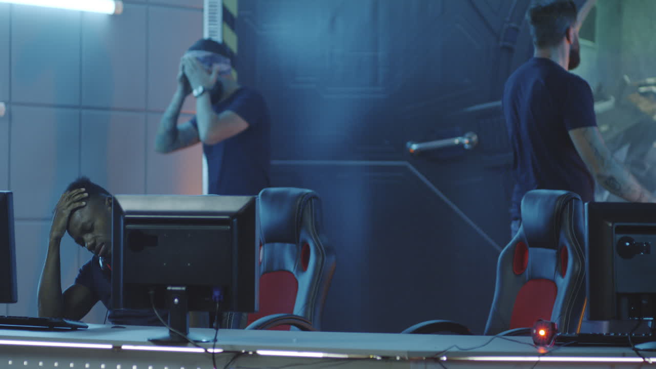 Gamer Destroying Keyboard after Losing Match Medium Shot of an Angry Gamer Destroying Keyboard after Losing a Match at a Gaming Tournament