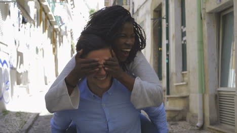 laughing multiracial couple having fun outdoor.