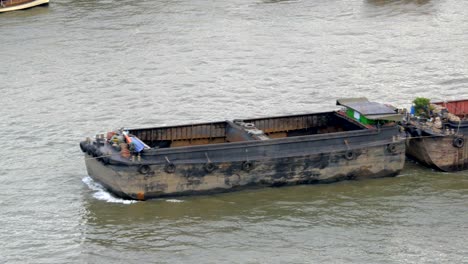 empty tugboat pulled by ship in chaopraya river, thailand