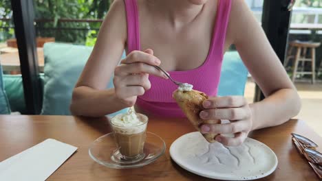 woman enjoying breakfast at a cafe