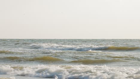 rough sea waves of baltic sea crashing on sandy coastline, static view