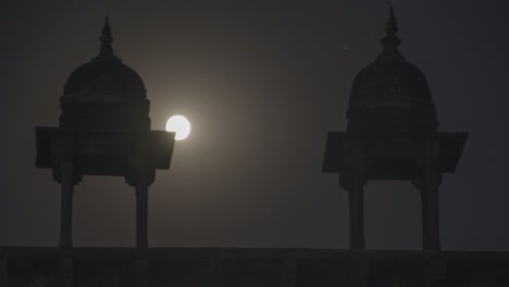 full moon over a historical landmark