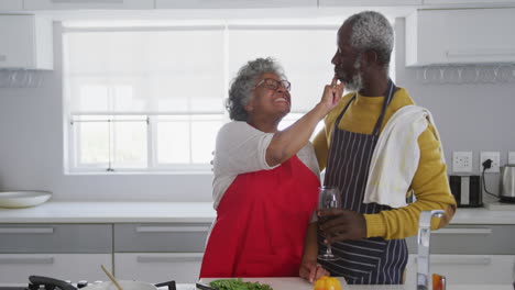 A-senior-African-american-couple-cooking-at-home.-Social-distancing-in-quarantine