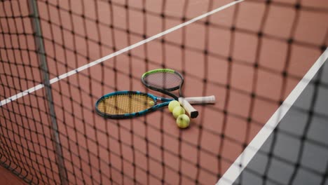 tennis rackets and balls on court