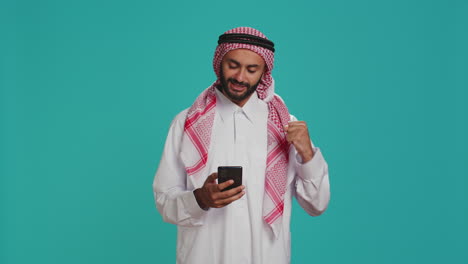 muslim person having smartphone in hands