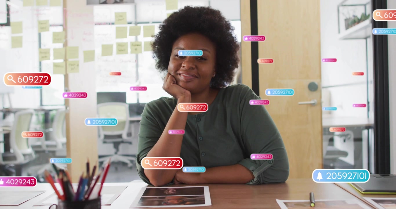 Content analyst woman tracking social media metrics as floating icons appearing, fading around desk