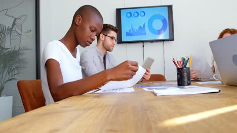 side view of young mixed-race business team working in meeting room of modern office 4k