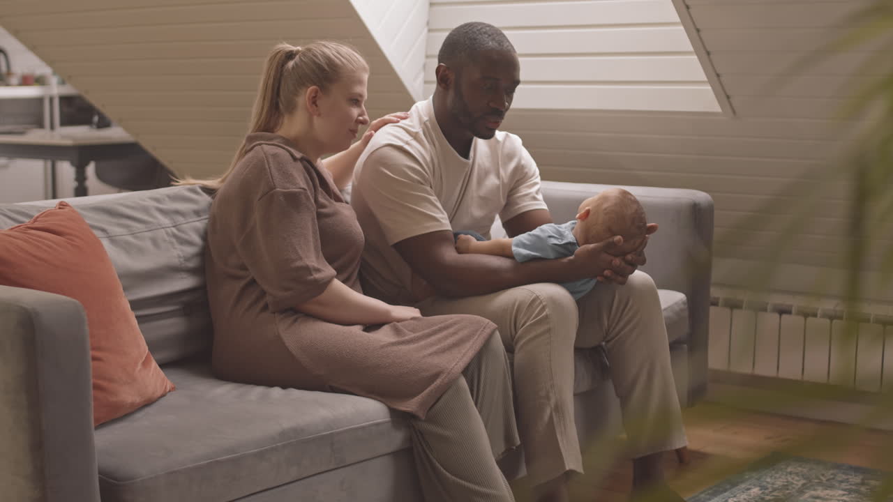 Parents Watching Baby Falling Asleep