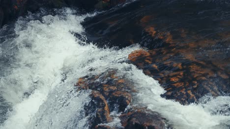 whitewater cascades over the dark chipped rocks