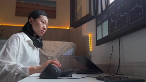 serious ethnic female trader analyzing cryptocurrency market statistics