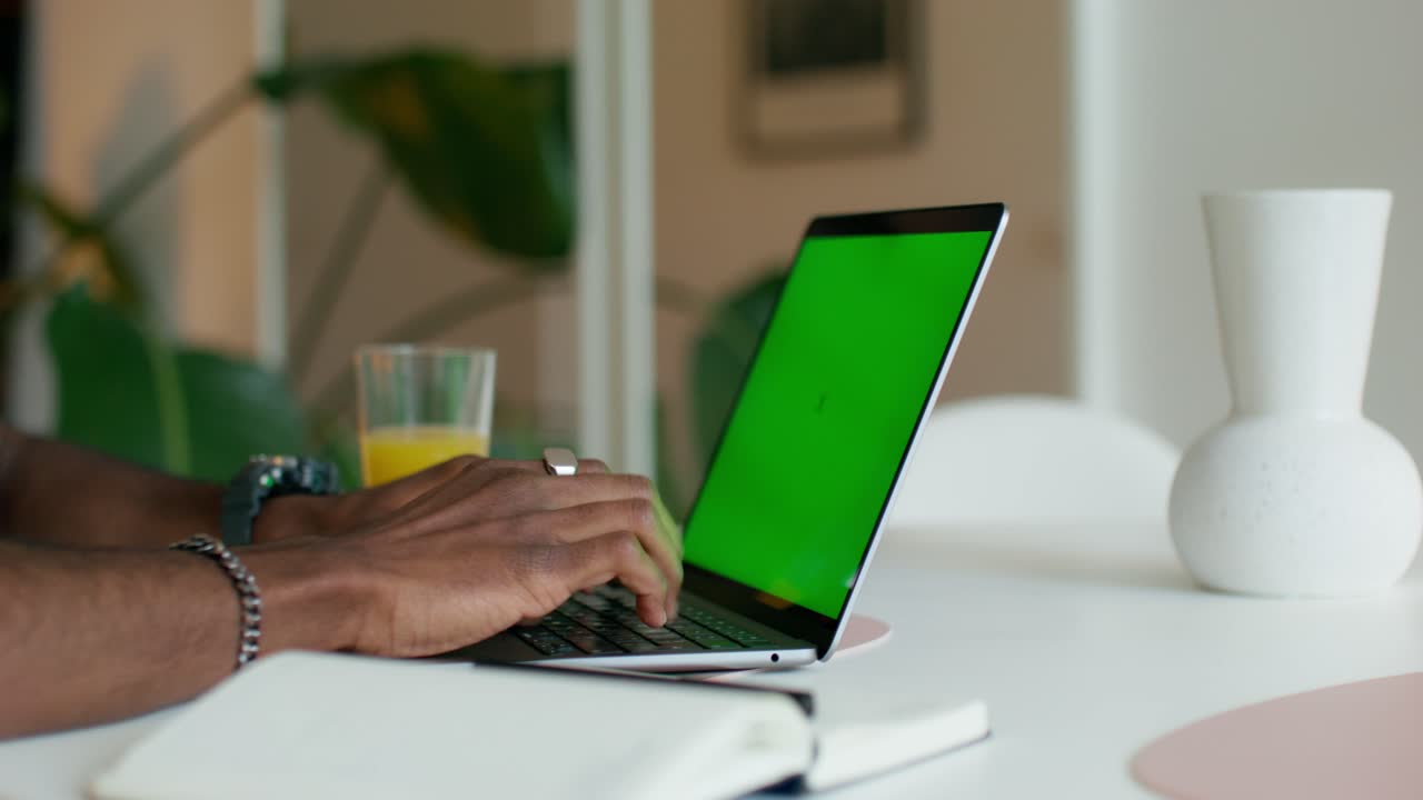 Man Working from Home on Laptop with Green Screen