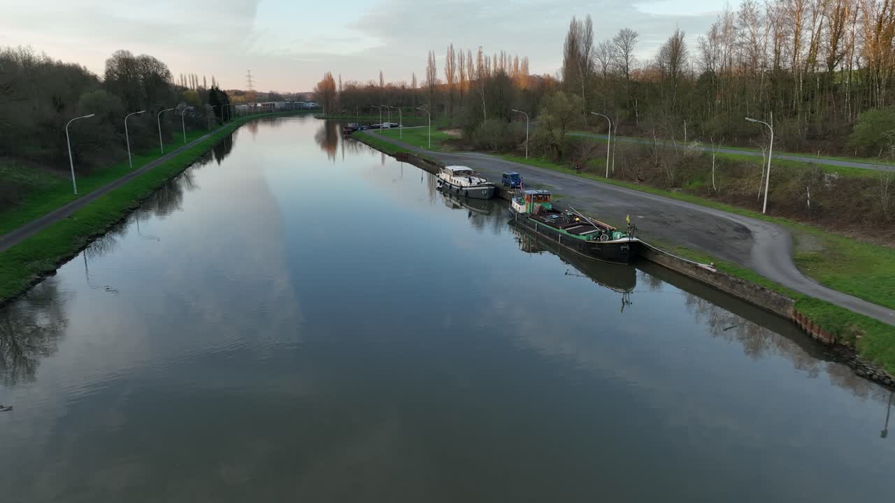 Cinematic zoom in over canal leading to historic architecture in Brussels, Belgium, on a bright afternoon